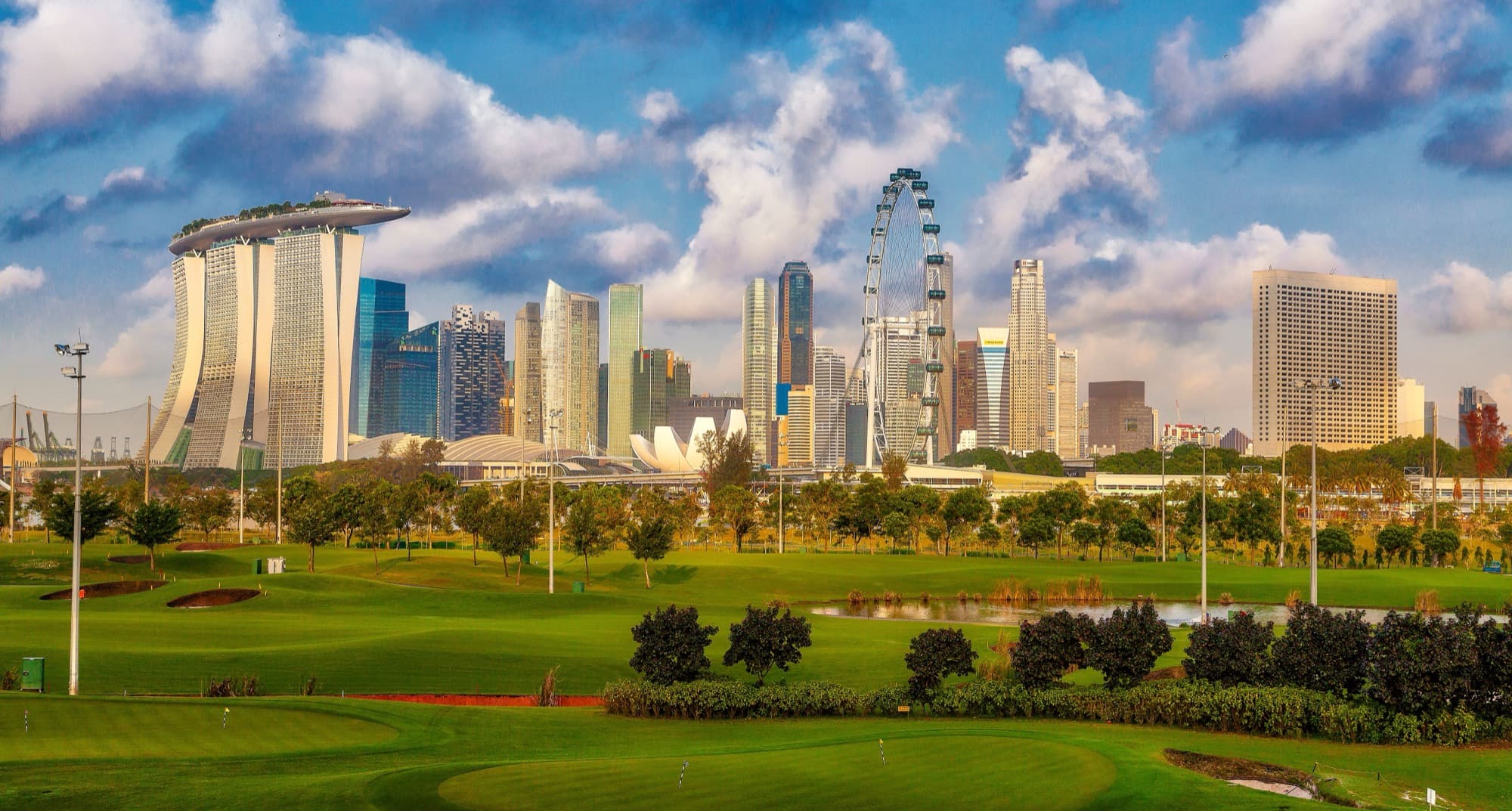 Singapore skyline viewed across a golf course, with Marina Bay Sands in the distance